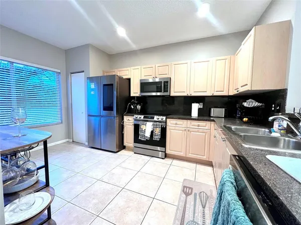 a kitchen with stainless steel appliances granite countertop a sink and cabinets