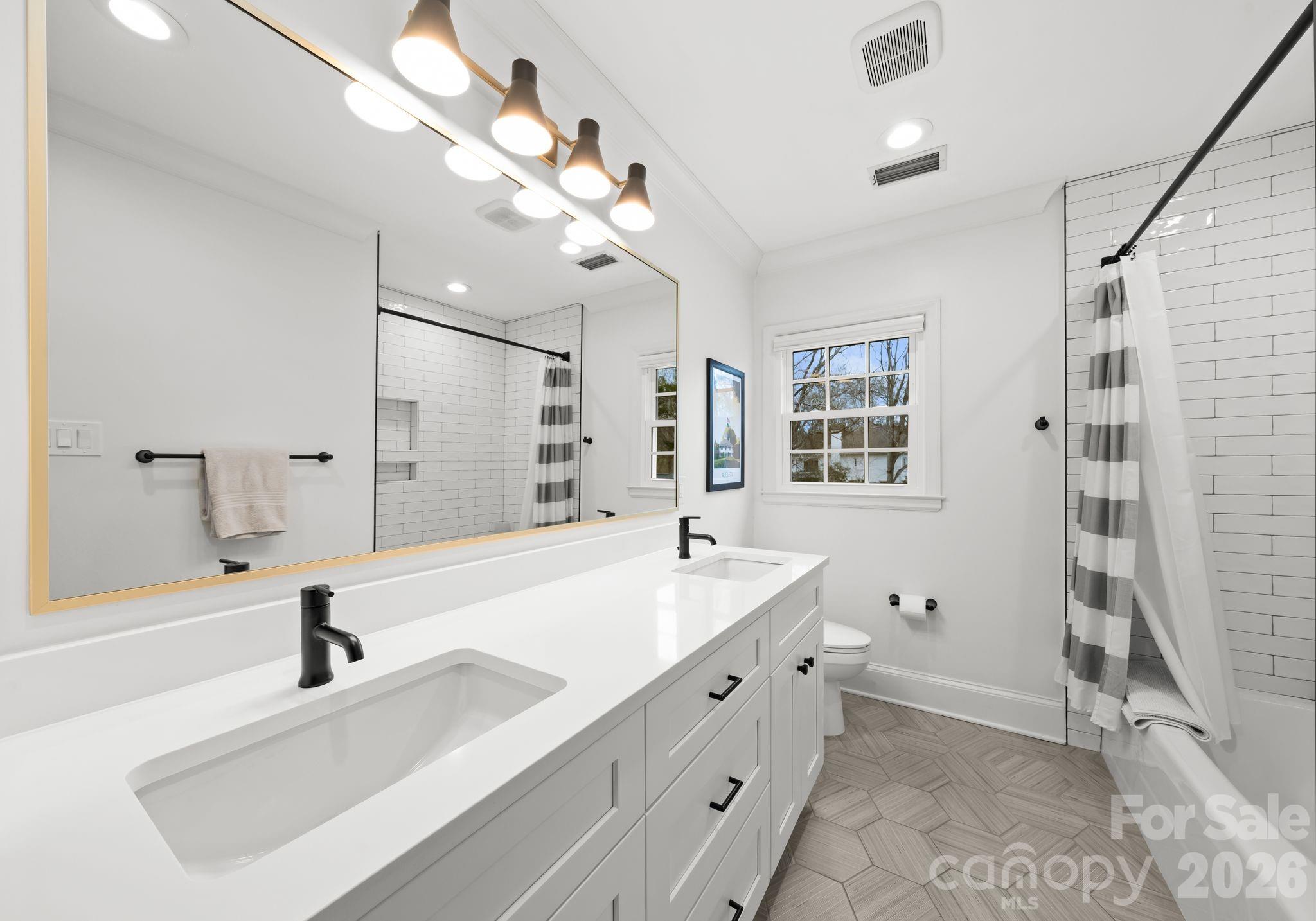 3800 River Ridge Road Charlotte, NC 28226 - Photo 34 of 48 a bathroom with a sink a toilet a large mirror and shower