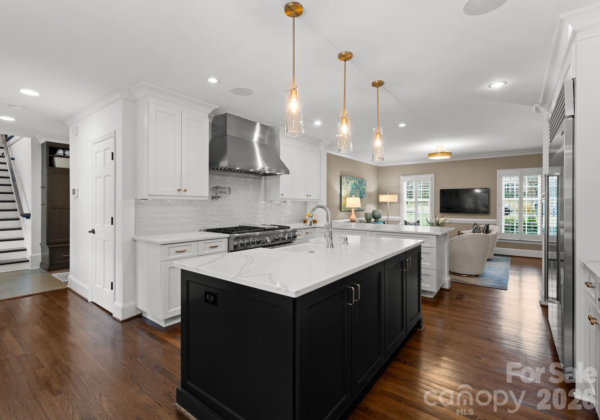 3800 River Ridge Road Charlotte, NC 28226 - Photo 9 of 48 a kitchen with kitchen island a sink stainless steel appliances and cabinets