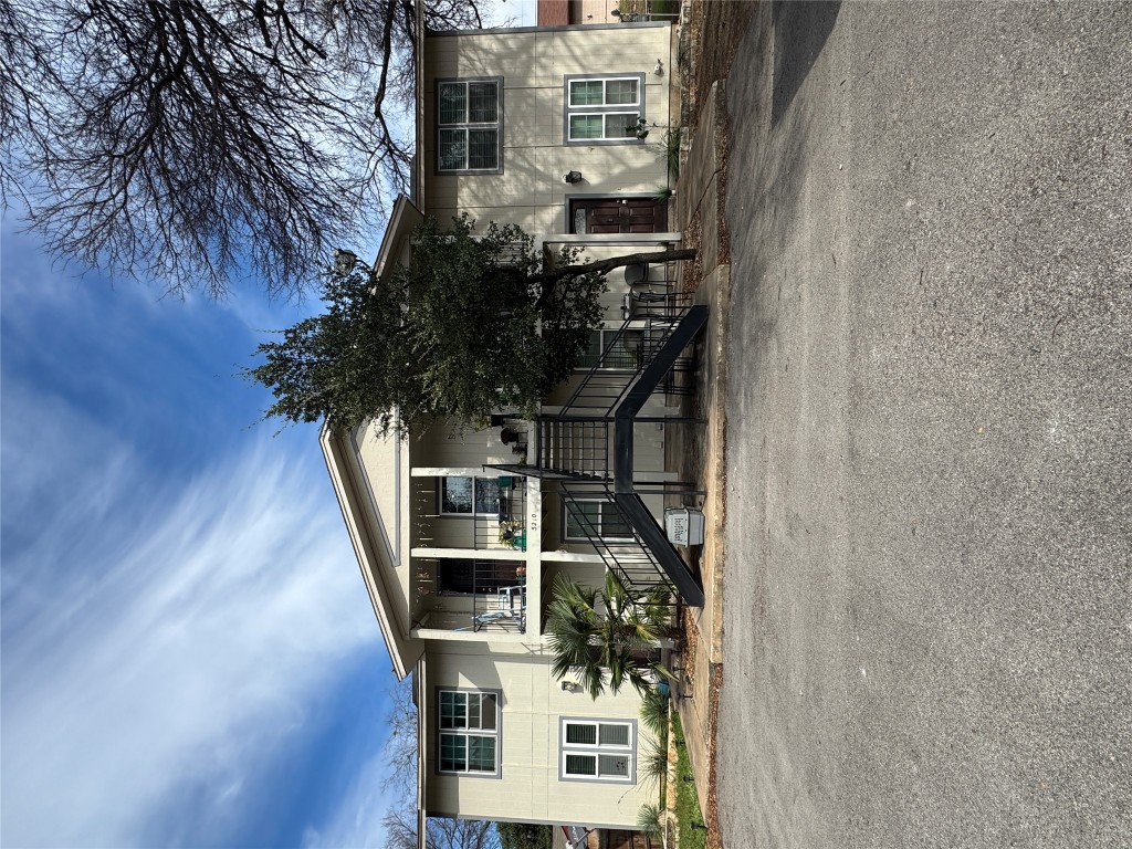 a view of a house with a patio and a yard