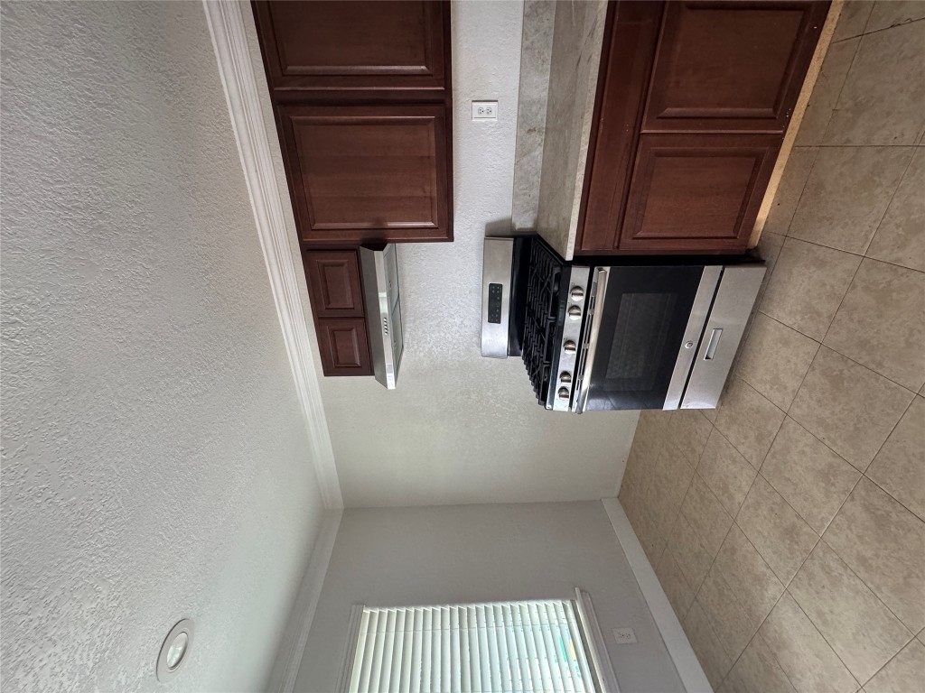 5210 Tahoe Trail, Unit D Austin, TX 78745 - Photo 3 of 10 a kitchen with a stove and a sink