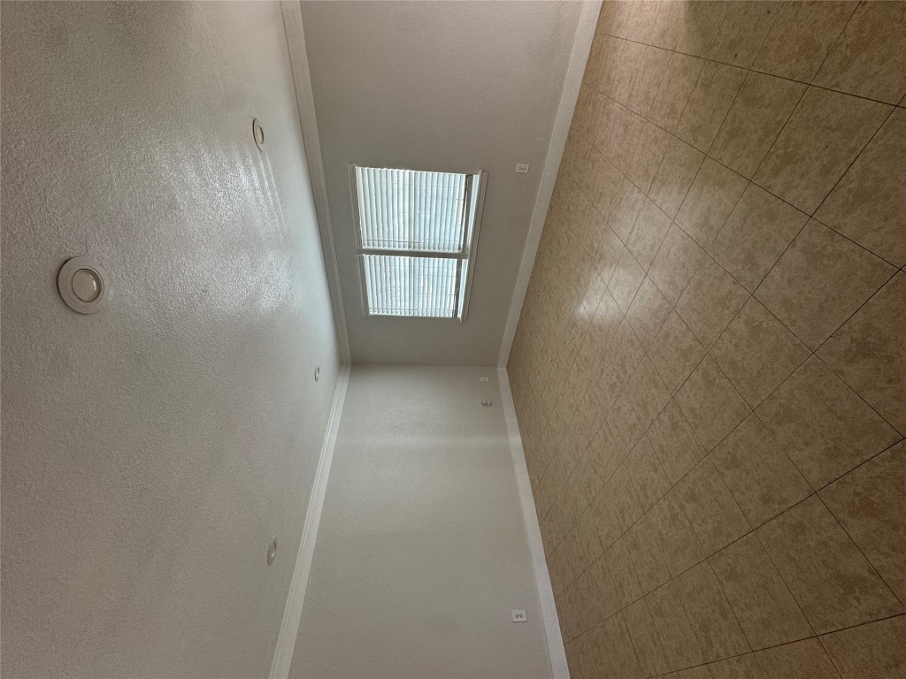 5210 Tahoe Trail, Unit D Austin, TX 78745 - Photo 8 of 10 an empty room with a empty space and windows
