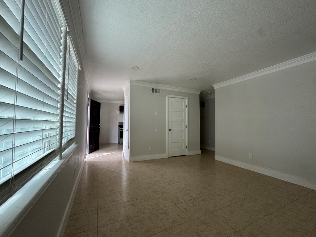5210 Tahoe Trail, Unit D Austin, TX 78745 - Photo 9 of 10 a view of an empty room with wooden floor and a window