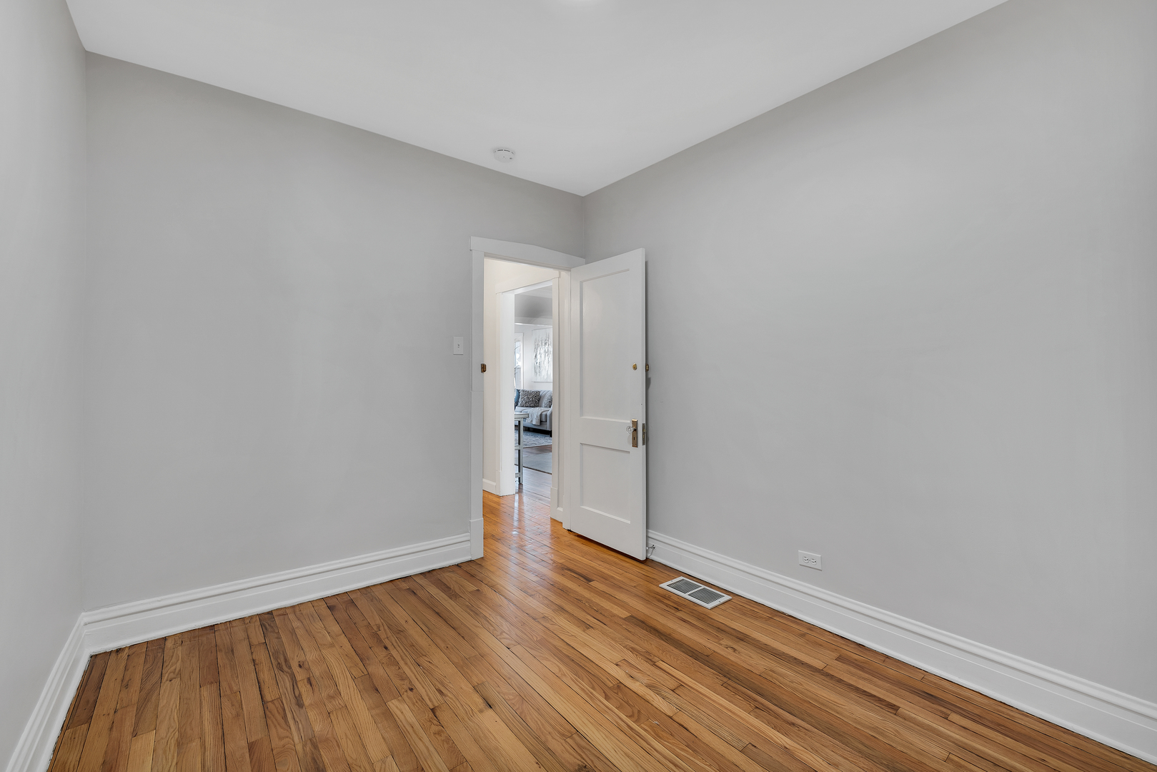 5237 West Henderson Street Chicago, IL 60641 - Photo 13 of 37 a view of an empty room with wooden floor