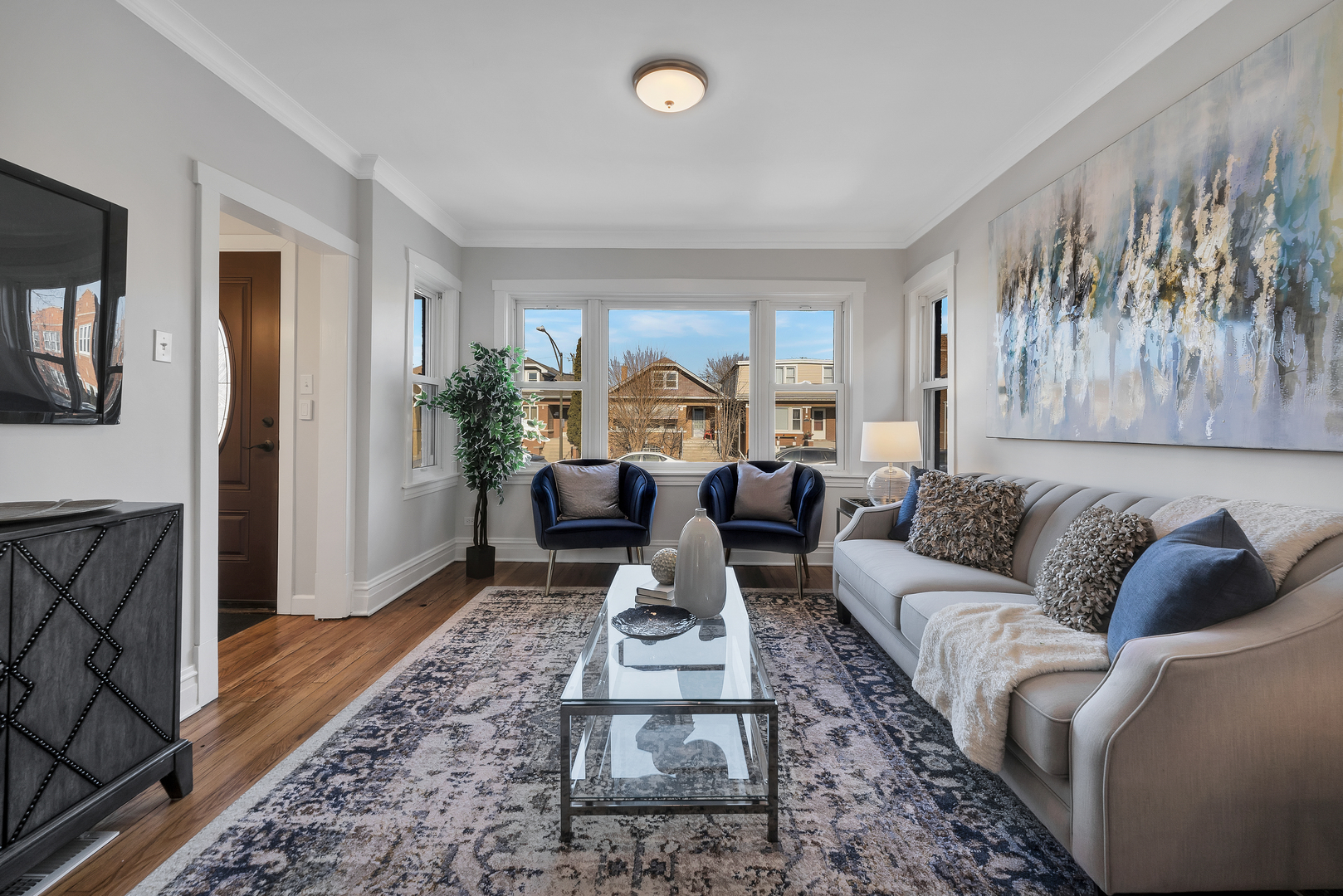5237 West Henderson Street Chicago, IL 60641 - Photo 8 of 37 a living room with furniture floor to ceiling window and a rug