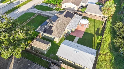an aerial view of a house with a yard