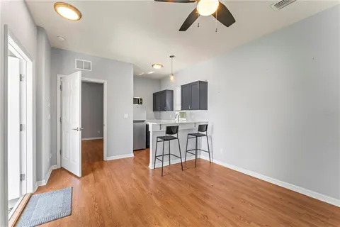 a view of a kitchen with furniture and wooden floor