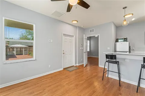 a workspace with wooden floor and a window