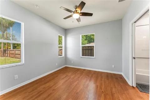 wooden floor in an empty room with a window