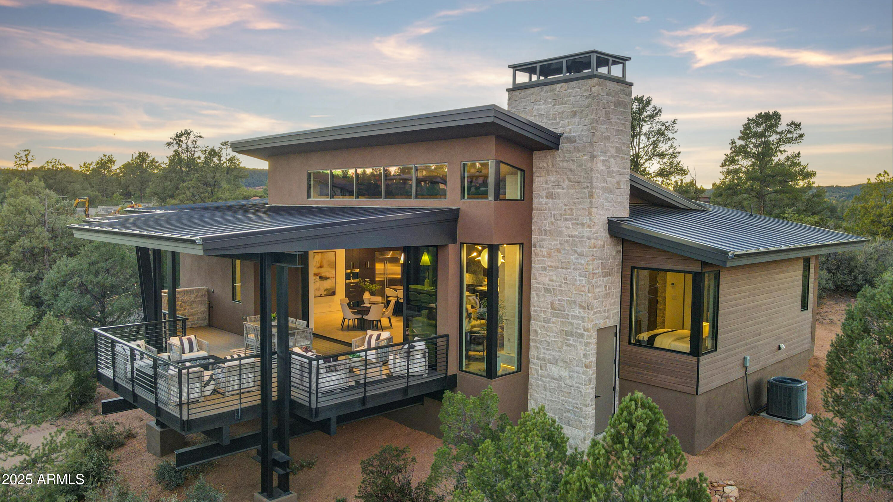 a view of a brick house with windows and wooden fence