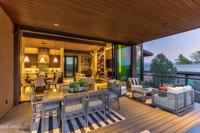 a roof deck with couches and wooden floor
