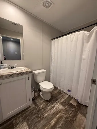 a bathroom with a toilet a sink and a mirror