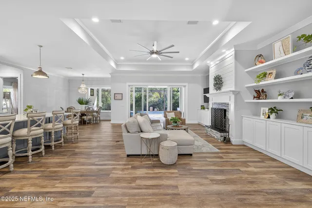 a kitchen with a dining table chairs wooden floor and appliances