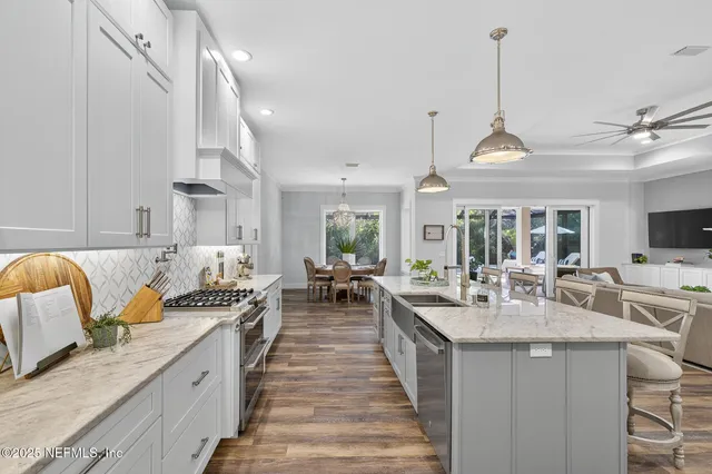 a bedroom with a large bed and a chandelier