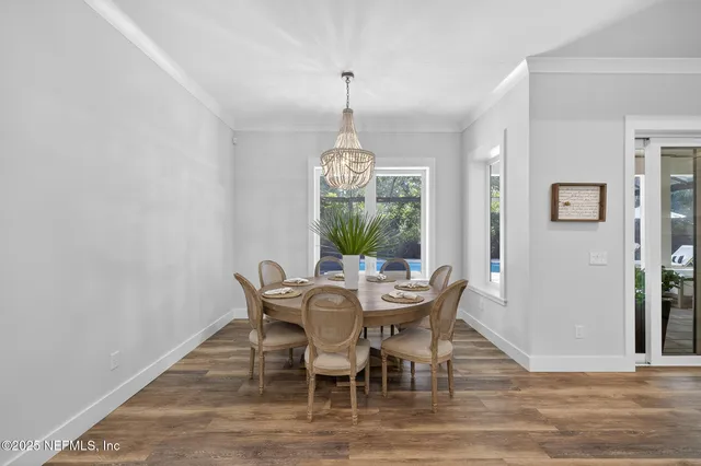 a bedroom with a bed and a flat tv screen on dresser
