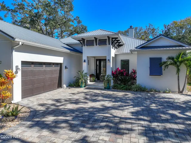 a potted plant in front of a yellow house