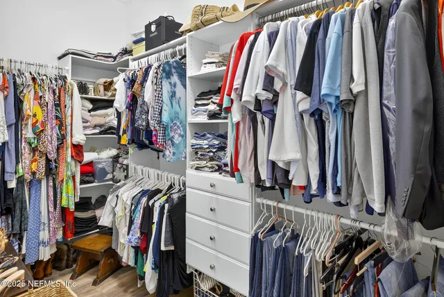 an aerial view of a house with outdoor space and trees all around