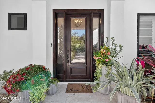 a white cabinet with a vase of flowers on it