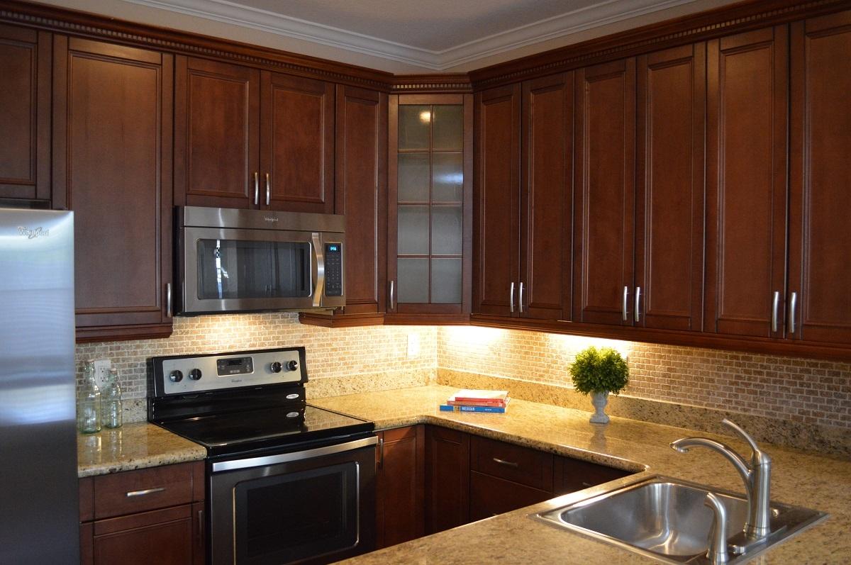 5968 Catesby Street Boca Raton, FL 33433 - Photo 7 of 23 a kitchen with granite countertop wooden cabinets and a stove top oven