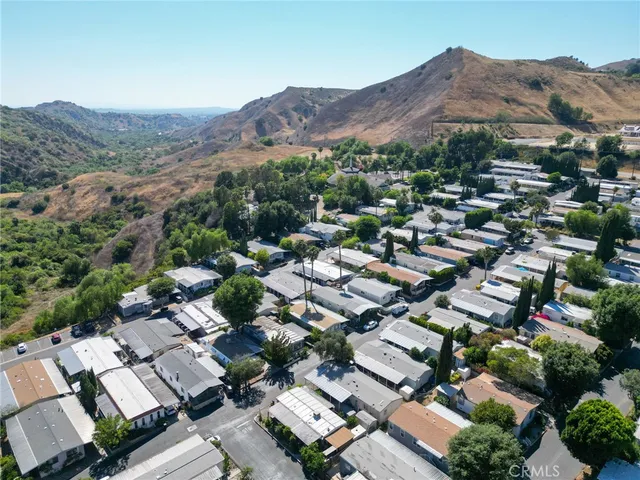 an aerial view of residential house with green space