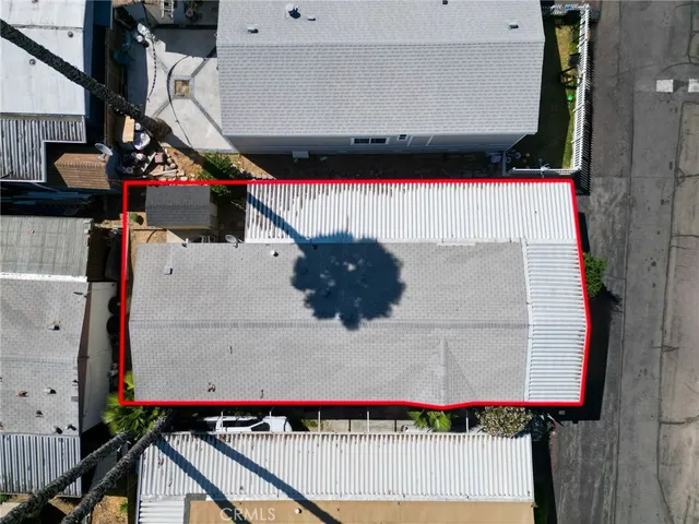 an aerial view of a house with garden space and street view