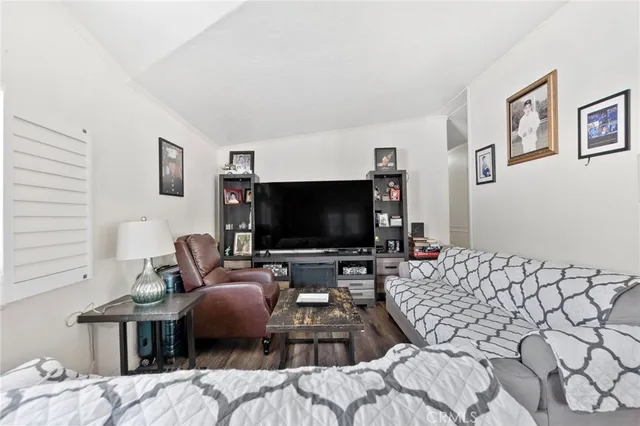 a bedroom with furniture and a flat screen tv