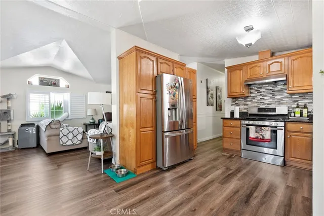 a kitchen with stainless steel appliances a refrigerator and a stove top oven