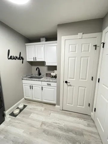 a view of a kitchen with white cabinets