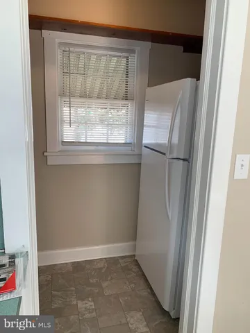 a view of a refrigerator in a kitchen