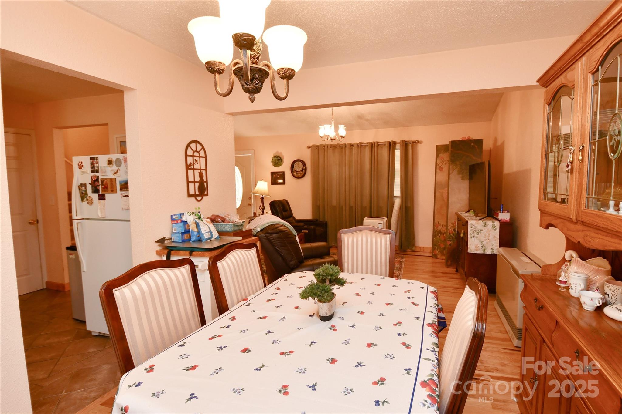 1227 Georges Fork Road Burnsville, NC 28714 - Photo 11 of 36 a view of a bedroom with furniture and chandelier