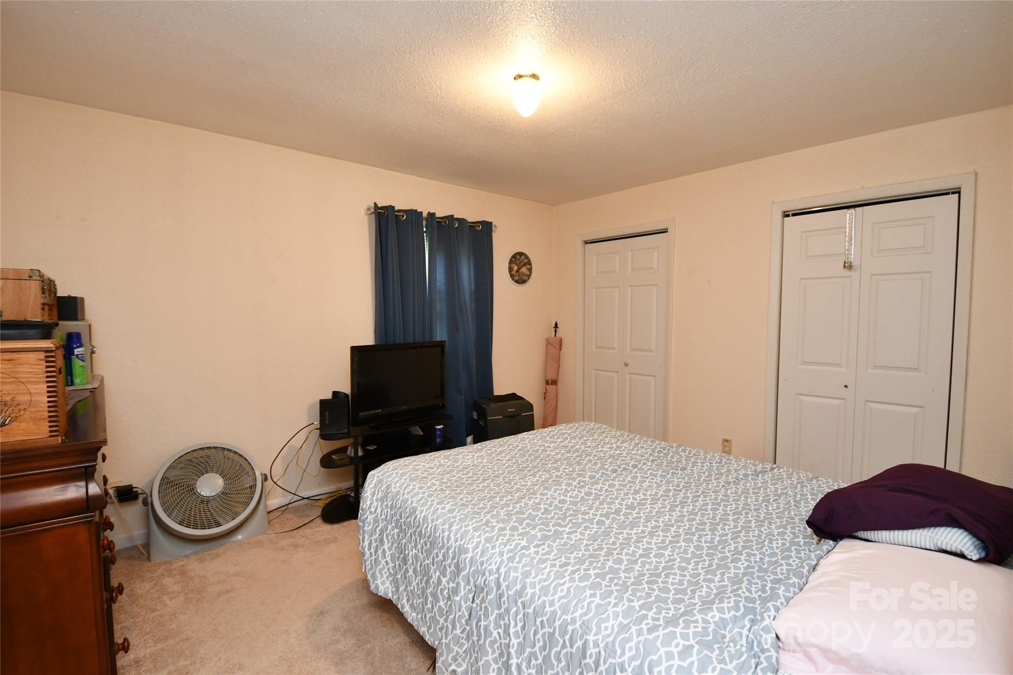 1227 Georges Fork Road Burnsville, NC 28714 - Photo 18 of 36 a bedroom with a bed and a television