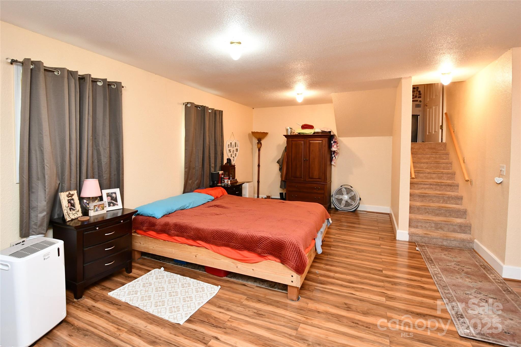 1227 Georges Fork Road Burnsville, NC 28714 - Photo 22 of 36 a bedroom with a bed and wooden floor