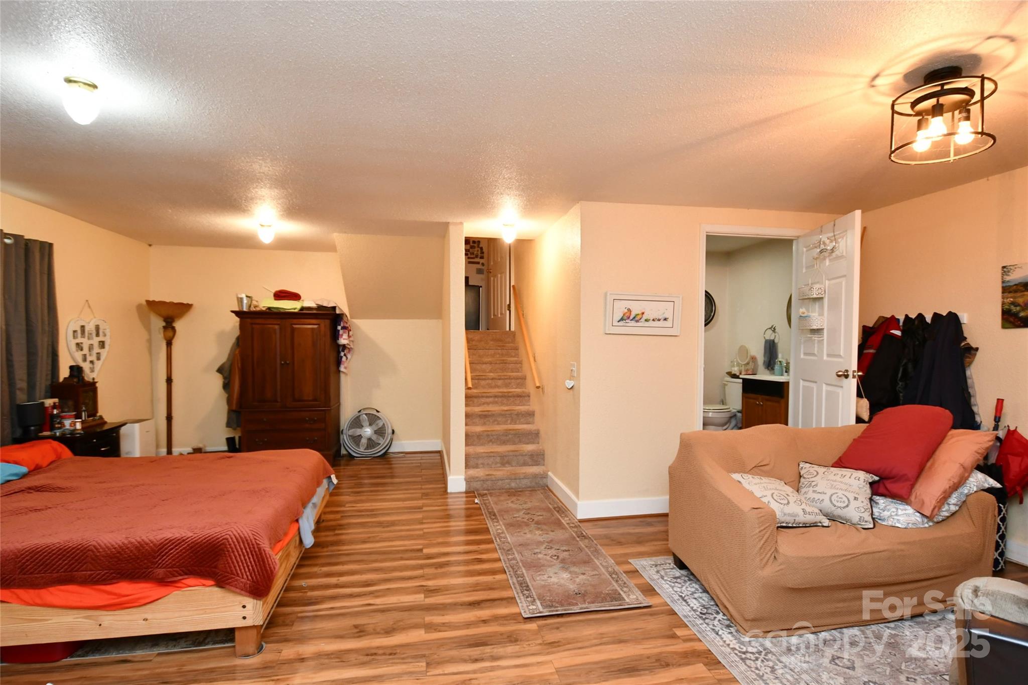 1227 Georges Fork Road Burnsville, NC 28714 - Photo 23 of 36 a bed room with a bed and a couch