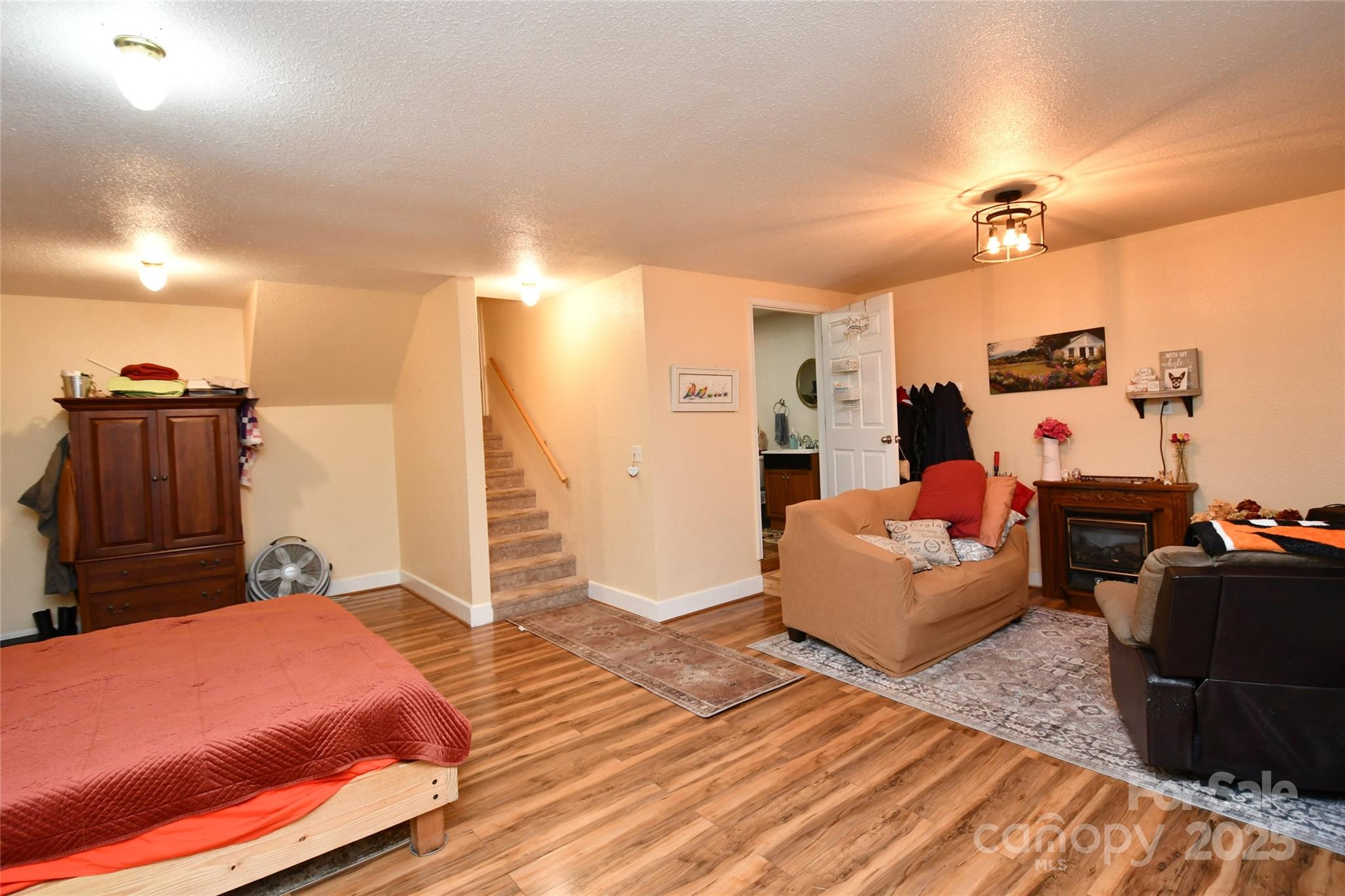 1227 Georges Fork Road Burnsville, NC 28714 - Photo 24 of 36 a bedroom with a bed and wooden floor