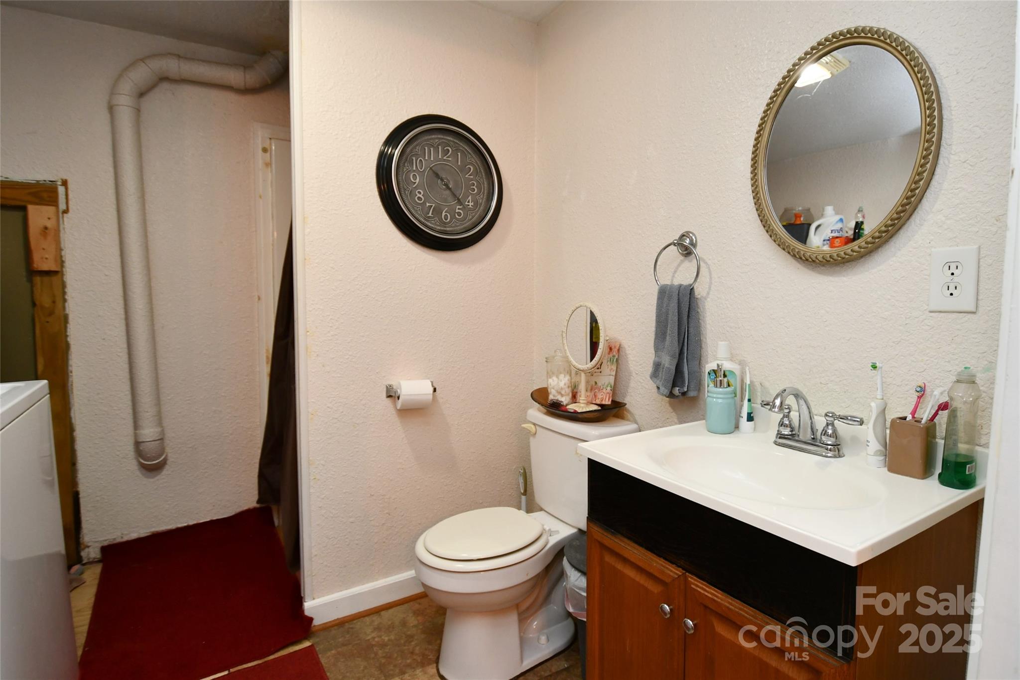 1227 Georges Fork Road Burnsville, NC 28714 - Photo 26 of 36 a bathroom with a sink mirror vanity and toilet