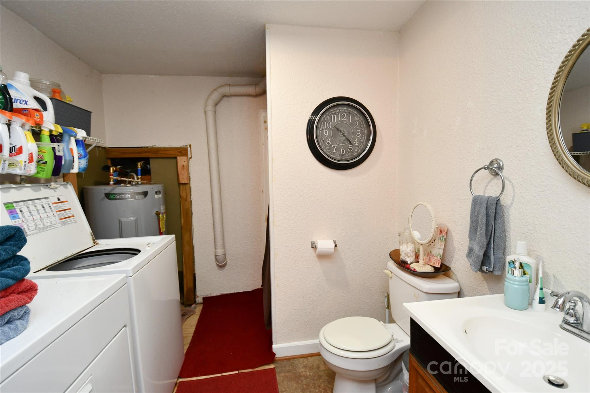 1227 Georges Fork Road Burnsville, NC 28714 - Photo 27 of 36 a view of bathroom with a toilet sink and mirror