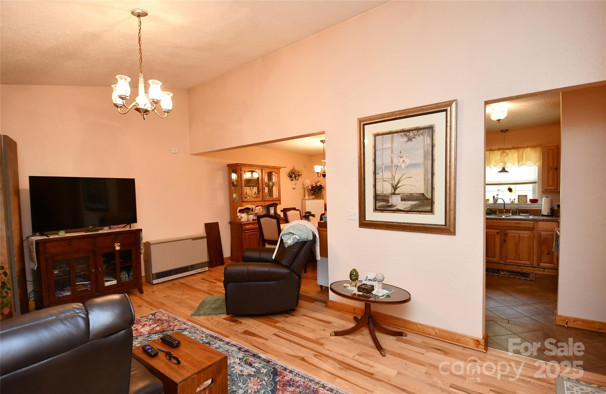 1227 Georges Fork Road Burnsville, NC 28714 - Photo 3 of 36 a living room with furniture a flat screen tv and kitchen view