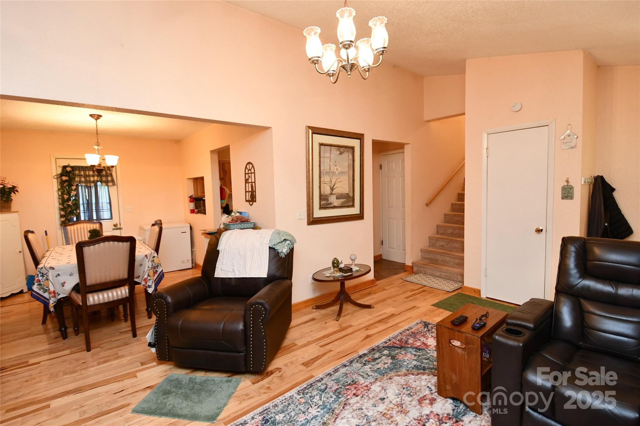 1227 Georges Fork Road Burnsville, NC 28714 - Photo 4 of 36 a living room with furniture two lamps and a dining table