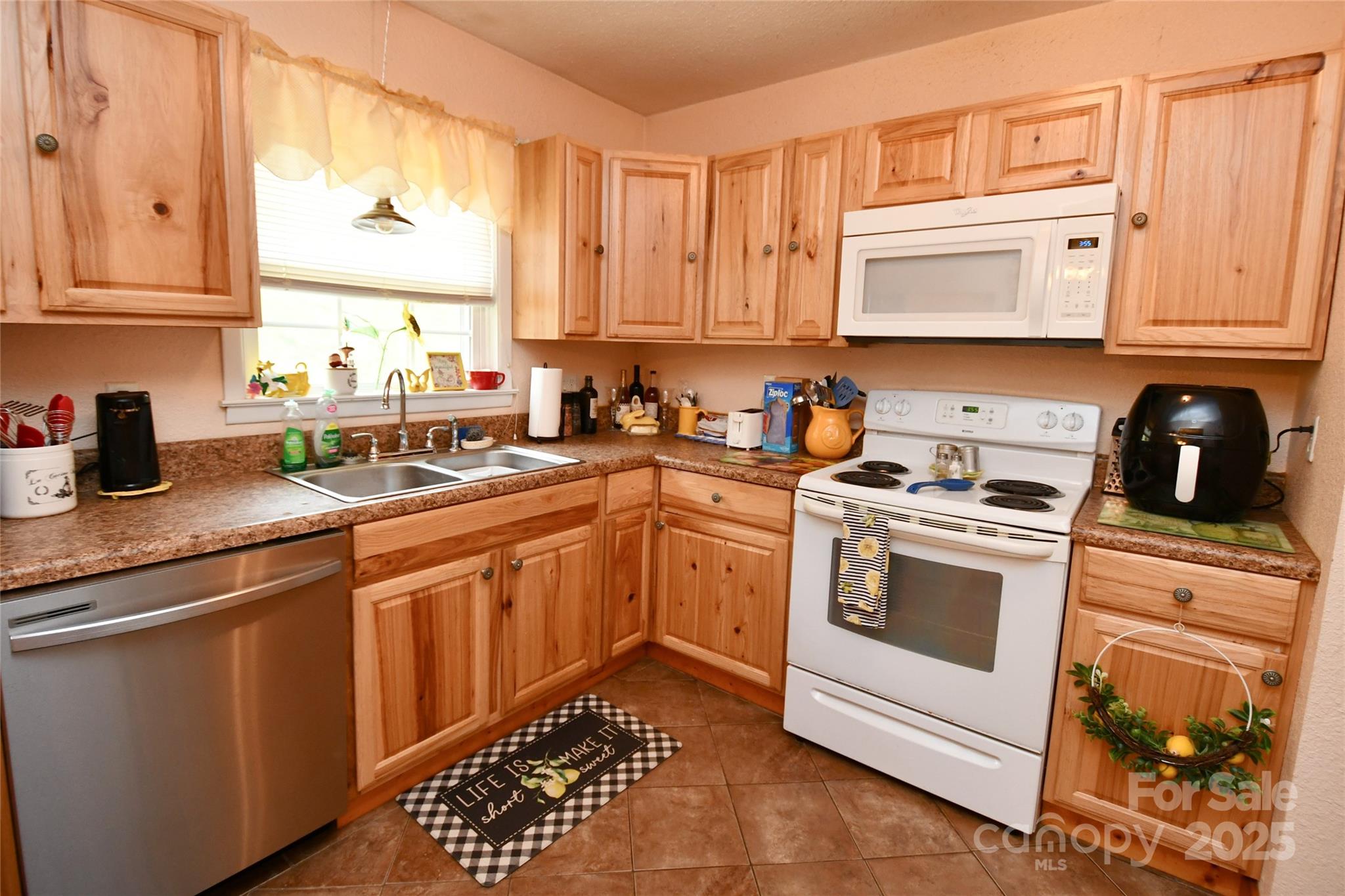 1227 Georges Fork Road Burnsville, NC 28714 - Photo 8 of 36 a kitchen with granite countertop a sink stainless steel appliances and cabinets