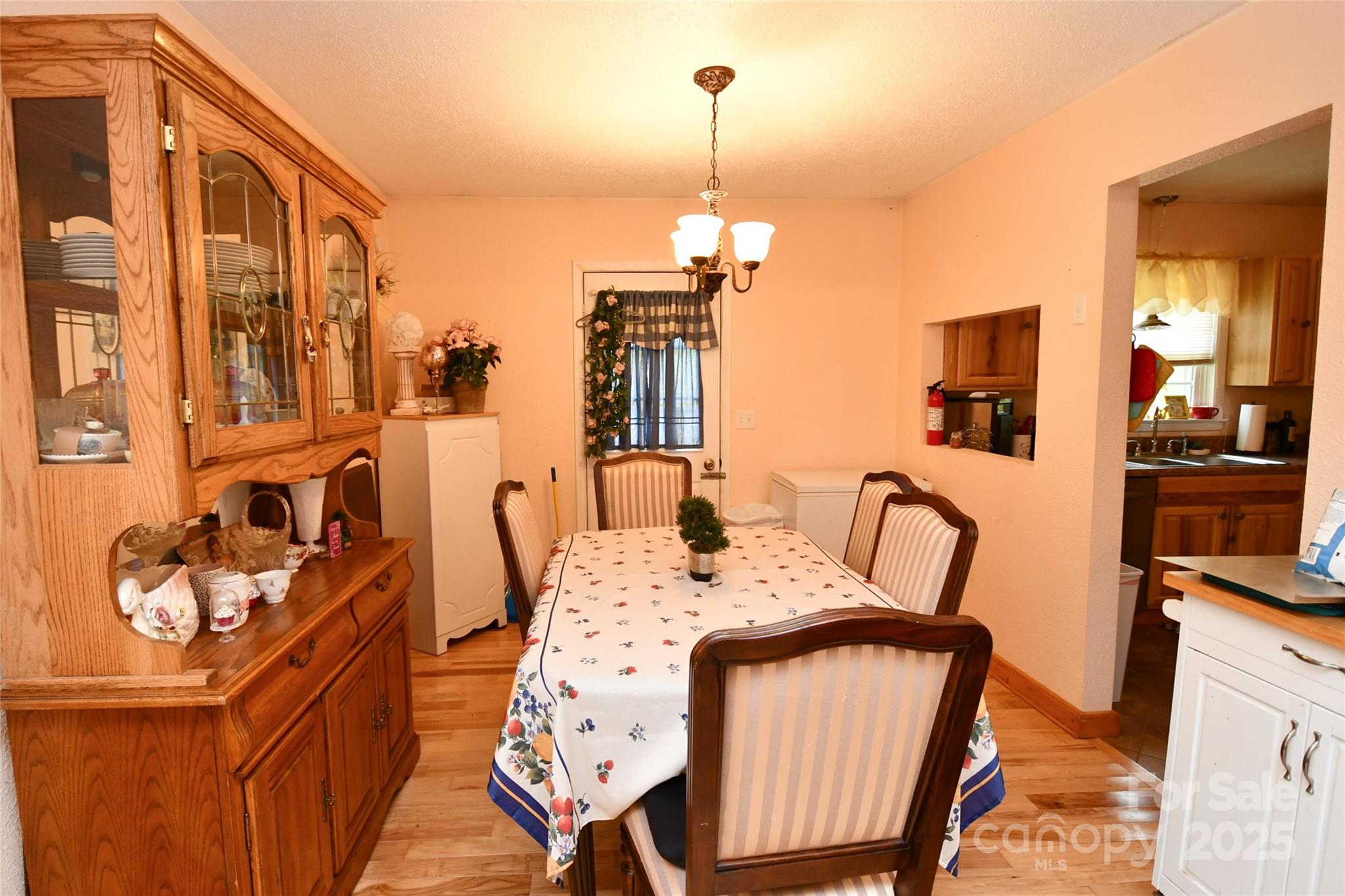 1227 Georges Fork Road Burnsville, NC 28714 - Photo 10 of 36 a view of a dining room with furniture and chandelier