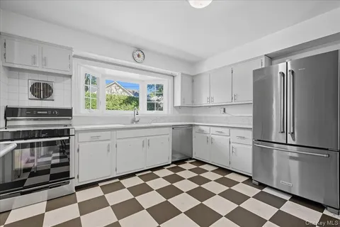 a kitchen with a stove a sink and a refrigerator