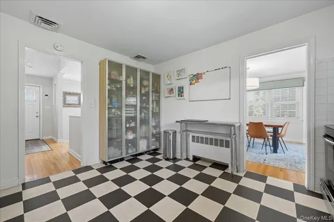 a view of a black and white checkered floor with a rug