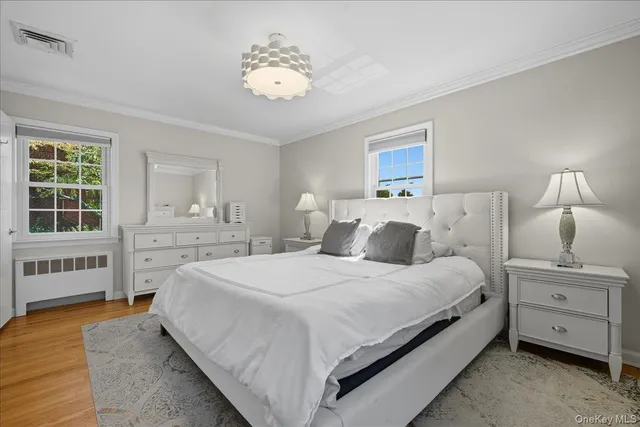 a spacious bedroom with a bed and a window