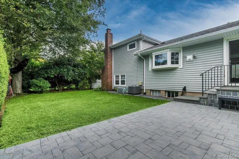 a view of a backyard with sitting area
