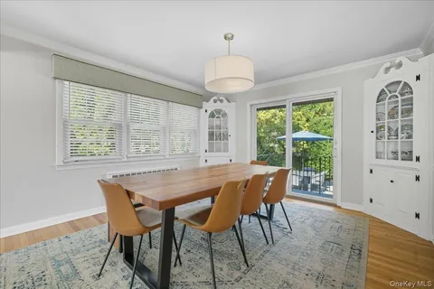 a dining room with furniture a chandelier and a rug