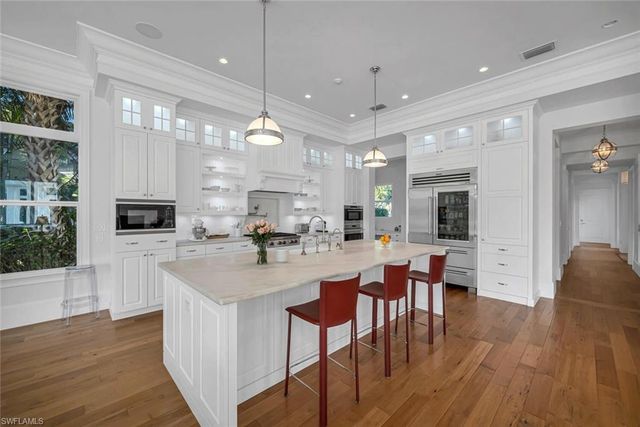 a large kitchen with a table and chairs
