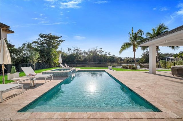 a view of swimming pool with seating space and yard