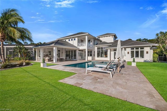 a view of a house with a backyard porch and sitting area