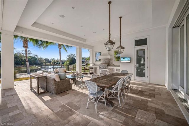 a dining room with furniture a chandelier and window