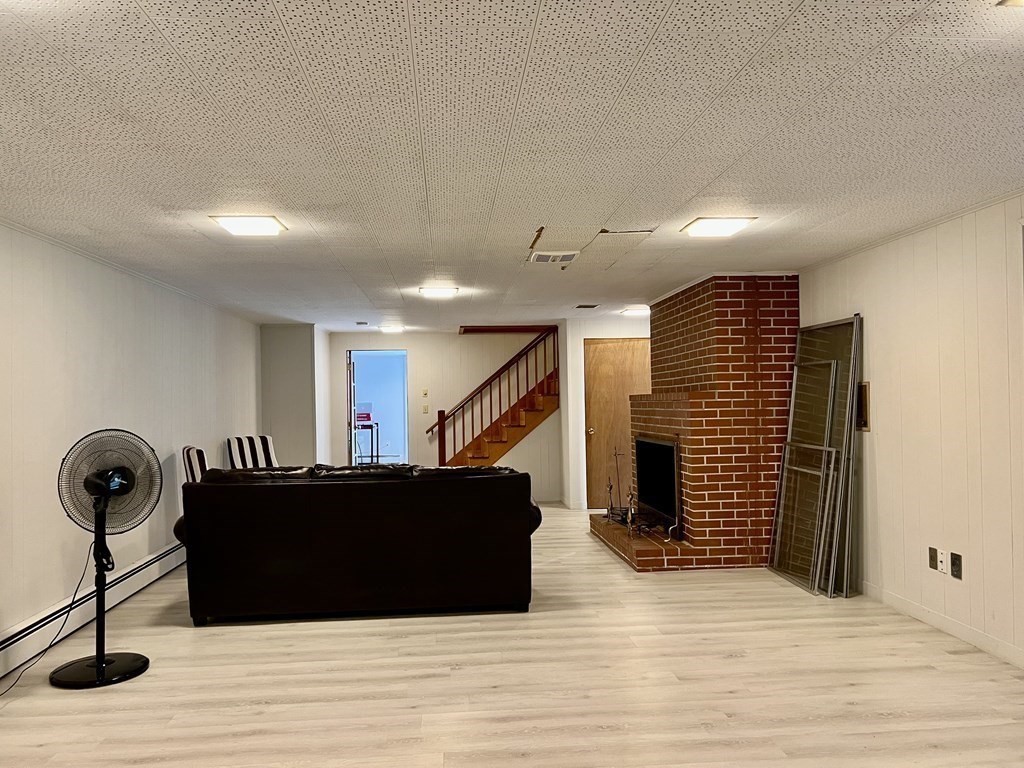 17 Shaker Road Ayer, MA 01432 - Photo 18 of 28 a view of a hall with stairs and a couch